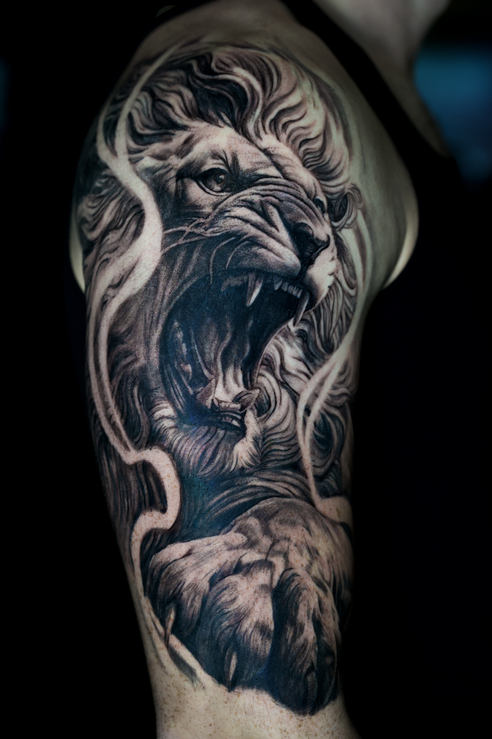 Lion upper arm tattoo